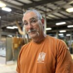 Man with glasses and orange shirt
