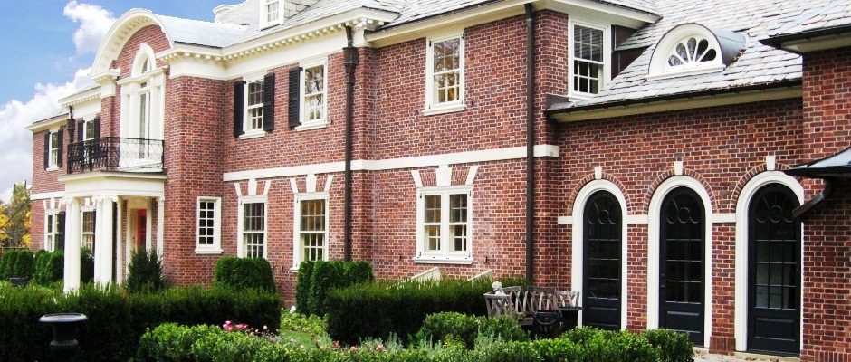 Brick home with custom arched top doors and porch columns